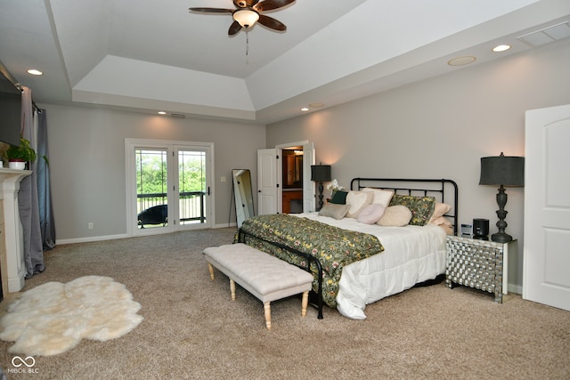 carpeted bedroom featuring access to outside, ceiling fan, and a raised ceiling