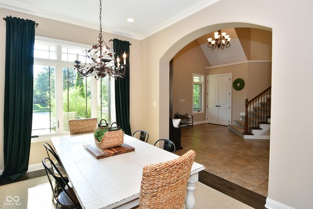 dining area with vaulted ceiling, a notable chandelier, and tile patterned floors