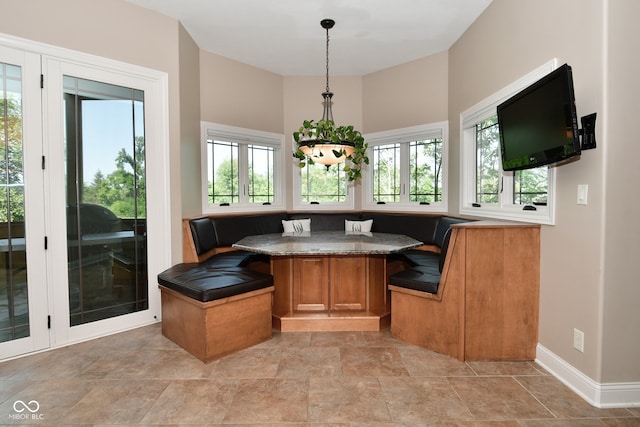 tiled dining space featuring breakfast area and a healthy amount of sunlight