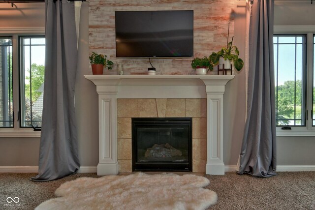 details with carpet flooring and a tiled fireplace