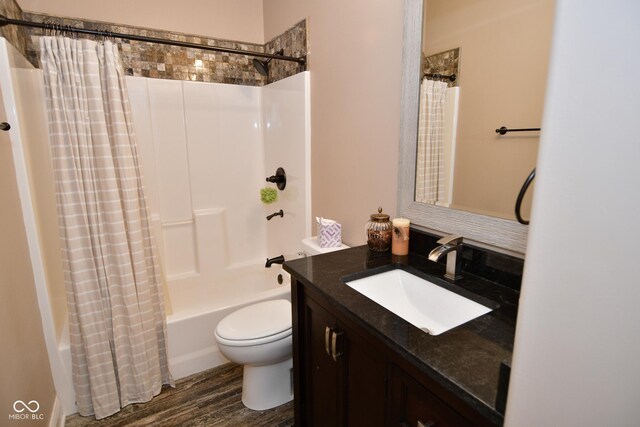 full bathroom with vanity, toilet, hardwood / wood-style floors, and shower / tub combo