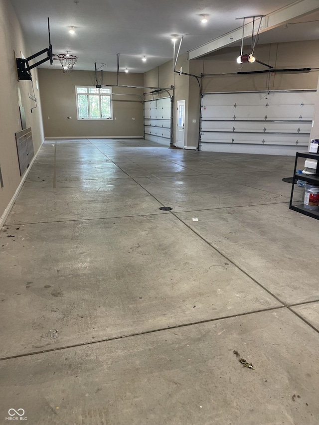 garage featuring baseboards and a garage door opener