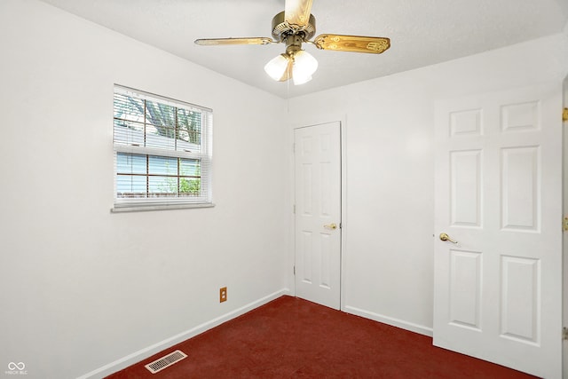 spare room featuring carpet floors and ceiling fan