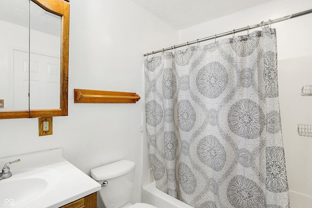 full bathroom featuring vanity, a textured ceiling, shower / bath combo, and toilet