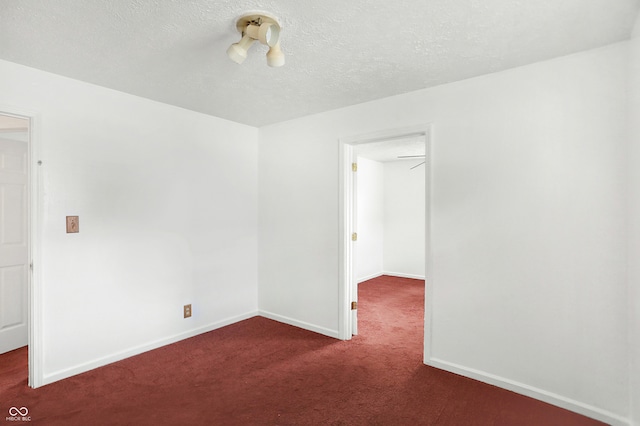 carpeted spare room featuring a textured ceiling