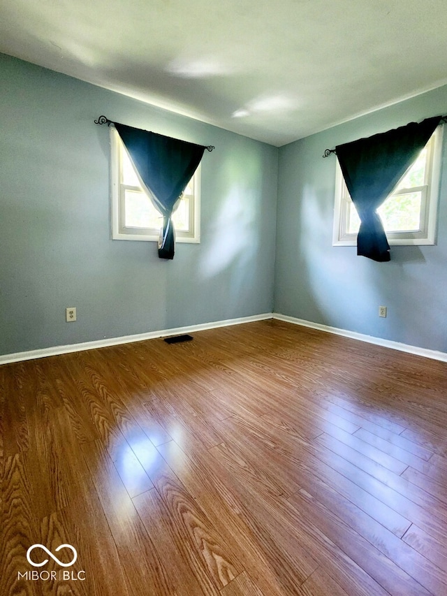 spare room with wood-type flooring