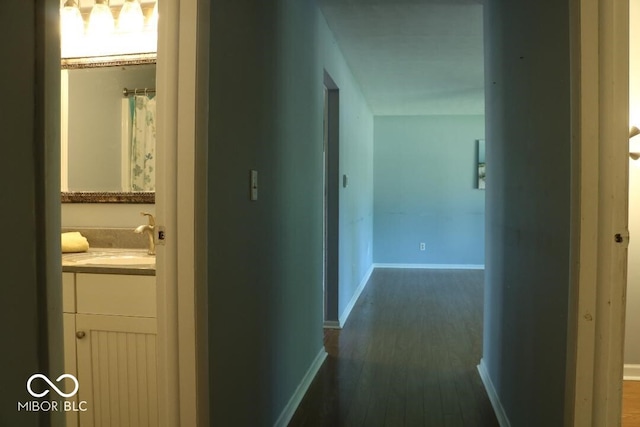 hall with dark wood-type flooring and sink