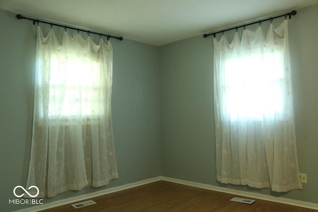 unfurnished room featuring hardwood / wood-style floors