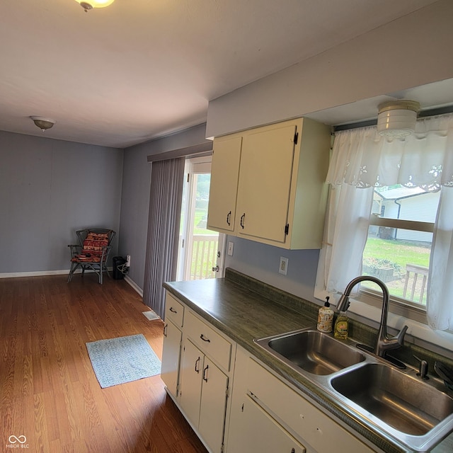 325 Franklin St, North Vernon, IN 47265 - kitchen featuring a sink, plenty of natural light, dark wood-style floors, and dark countertops