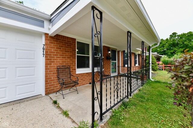 exterior space with covered porch and a garage