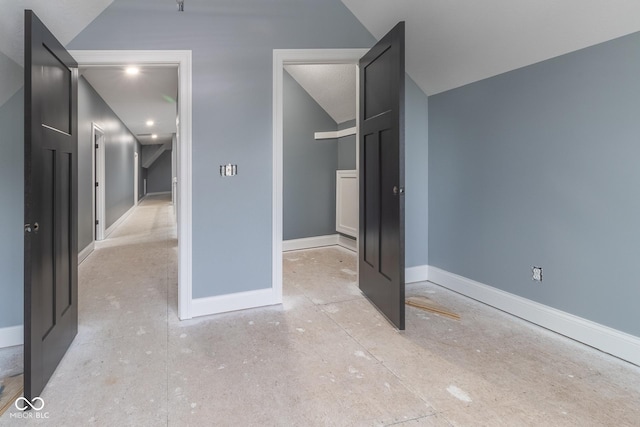 unfurnished bedroom with lofted ceiling