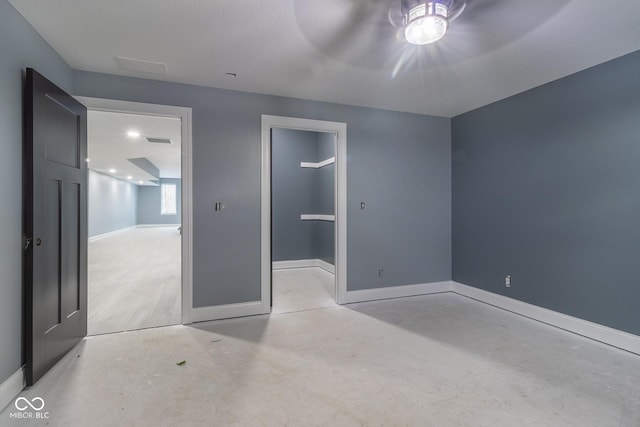 unfurnished bedroom featuring a closet and a walk in closet