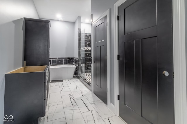 bathroom featuring tile walls and a tub to relax in