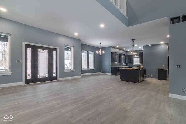 kitchen featuring hanging light fixtures, light wood-type flooring, a chandelier, and a kitchen island