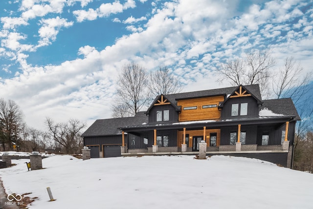 view of front of home featuring covered porch and a garage