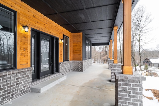 snow covered patio with covered porch