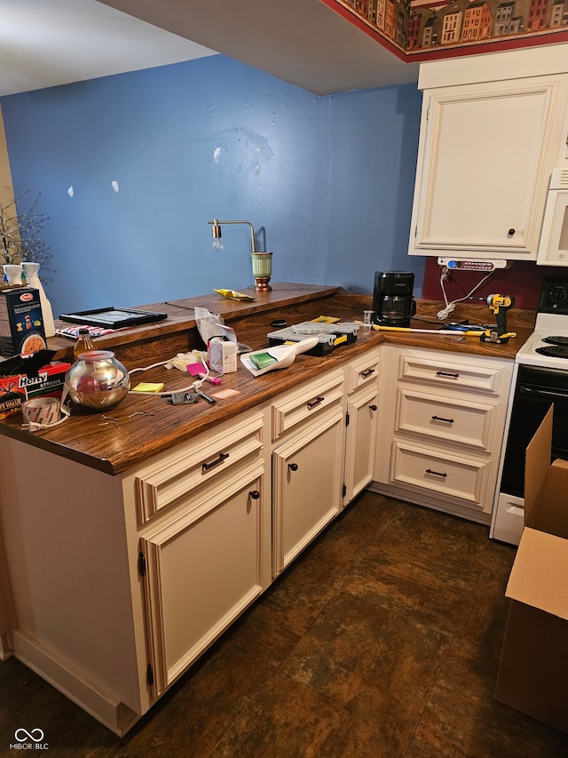 kitchen with white appliances, kitchen peninsula, and white cabinetry