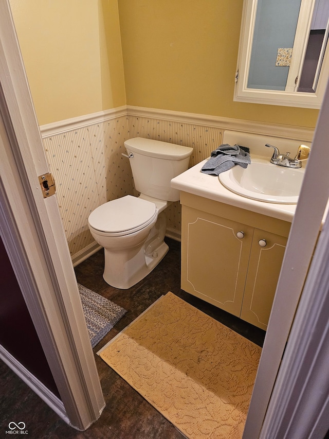 bathroom featuring vanity, toilet, and hardwood / wood-style flooring