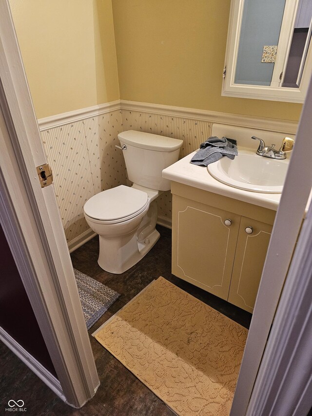 14 Winchester Ct, Anderson, IN 46013 - bathroom featuring toilet, wainscoting, and vanity