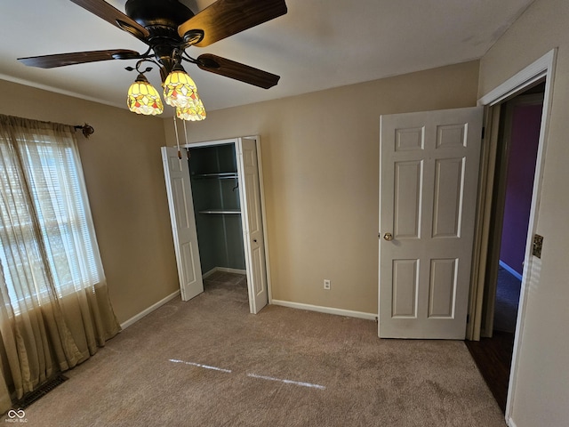 14 Winchester Ct, Anderson, IN 46013 - unfurnished bedroom with baseboards, carpet flooring, ceiling fan, and a closet