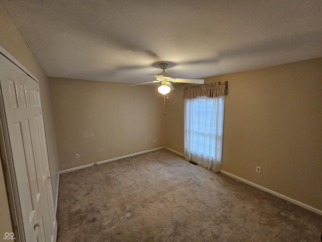 14 Winchester Ct, Anderson, IN 46013 - unfurnished bedroom with carpet flooring, a ceiling fan, baseboards, and a closet