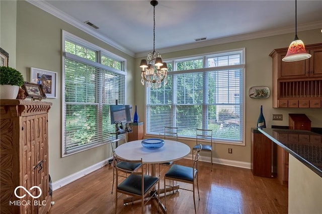 dining area featuring crown molding, a notable chandelier, and dark hardwood / wood-style flooring