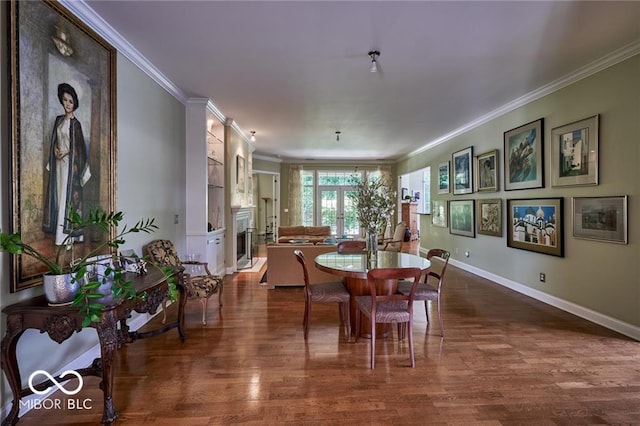 dining area featuring dark hardwood / wood-style flooring and crown molding