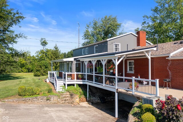 back of property featuring a yard and central AC unit