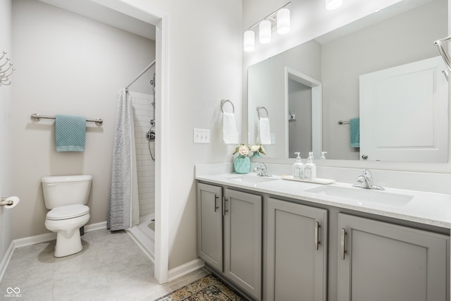 bathroom featuring curtained shower, tile patterned flooring, toilet, and vanity