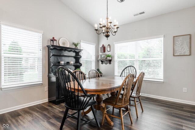 dining area featuring lofted ceiling, dark hardwood / wood-style floors, and an inviting chandelier