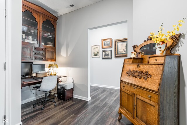 home office with dark hardwood / wood-style flooring