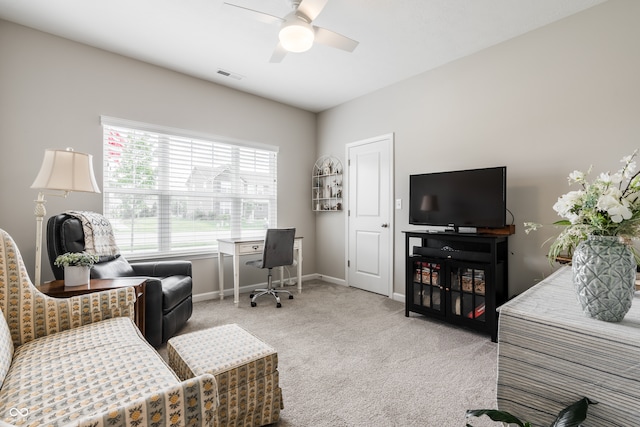 carpeted living room with ceiling fan