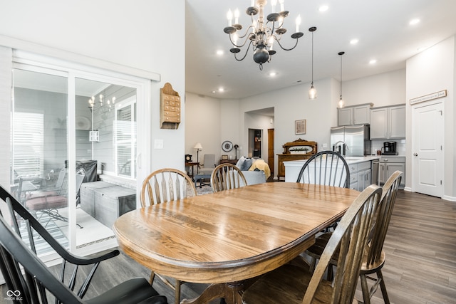 dining space featuring wood-type flooring and a chandelier