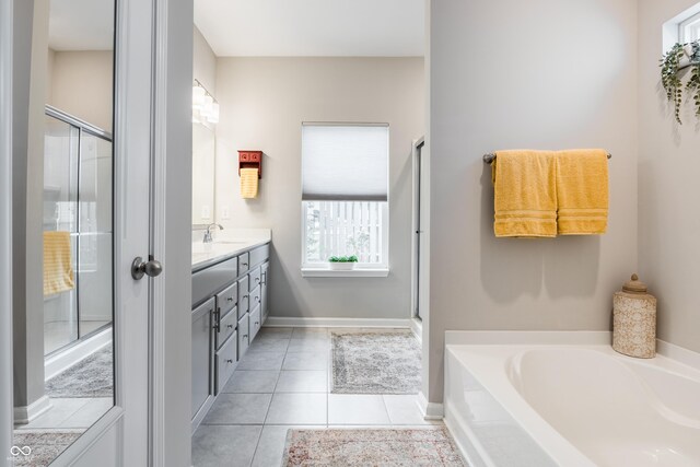 bathroom with vanity, tile patterned floors, and shower with separate bathtub