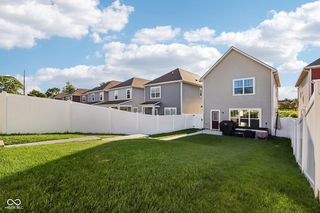 rear view of property with a lawn