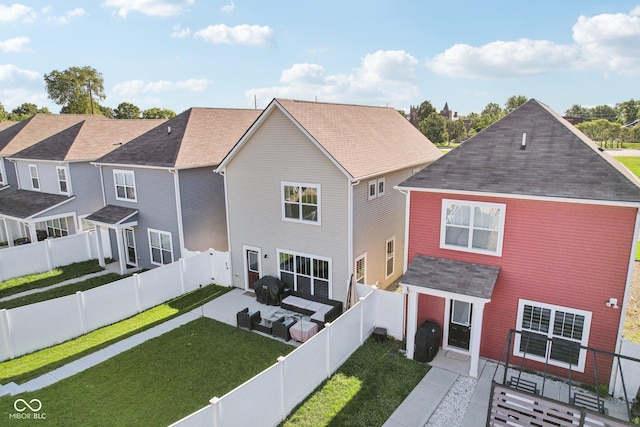 rear view of property featuring an outdoor hangout area, a patio, and a yard