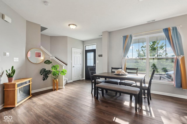 dining area featuring dark wood-type flooring