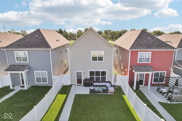 rear view of property with a yard and a patio