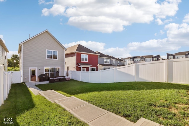 rear view of property with a yard