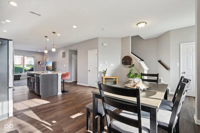 dining space featuring dark hardwood / wood-style floors and sink