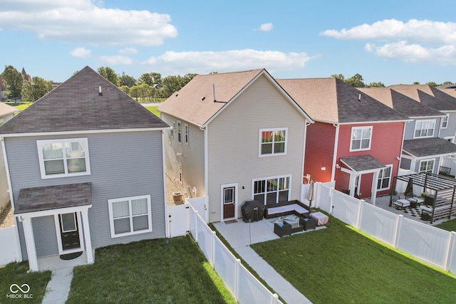 rear view of house with a lawn and a patio