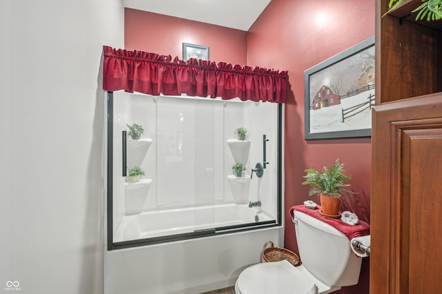 bathroom featuring shower / bath combination with glass door and toilet