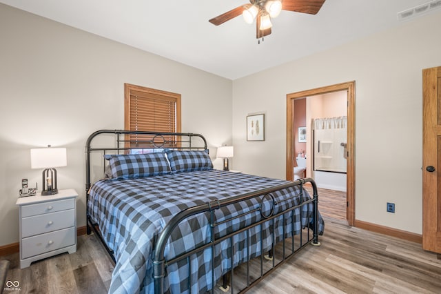 bedroom with connected bathroom, hardwood / wood-style flooring, and ceiling fan