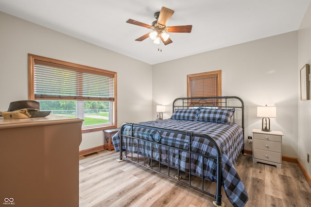 bedroom featuring light hardwood / wood-style floors and ceiling fan