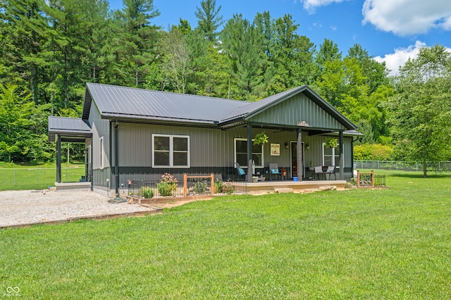 rear view of house featuring a yard