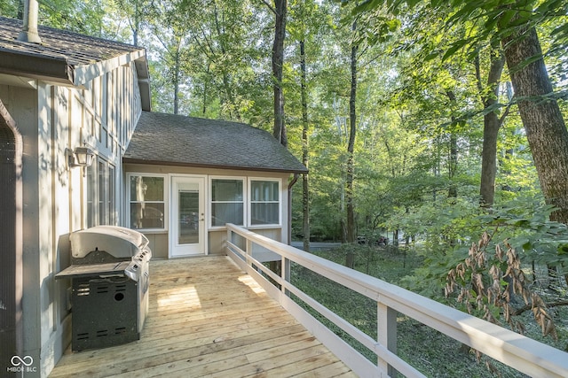 wooden terrace featuring a grill