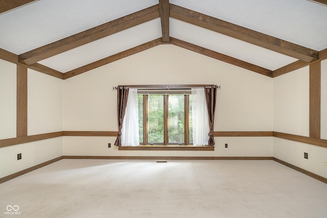 empty room with vaulted ceiling with beams, visible vents, baseboards, and carpet flooring