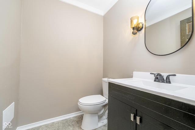 half bath with toilet, baseboards, and vanity