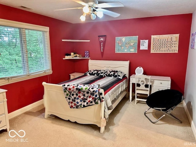 bedroom with light carpet and ceiling fan