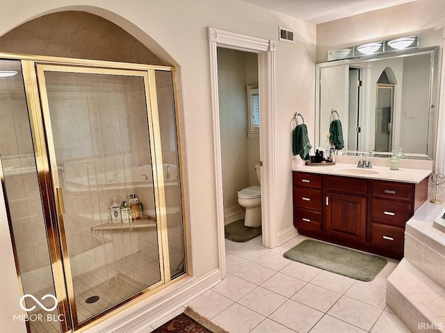 full bathroom with vanity, tile patterned floors, toilet, and separate shower and tub